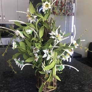Faux white flowers in imitation wood planter